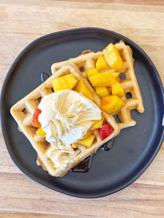 Mango whipped cream frosting with mango fruit and breakfast waffles